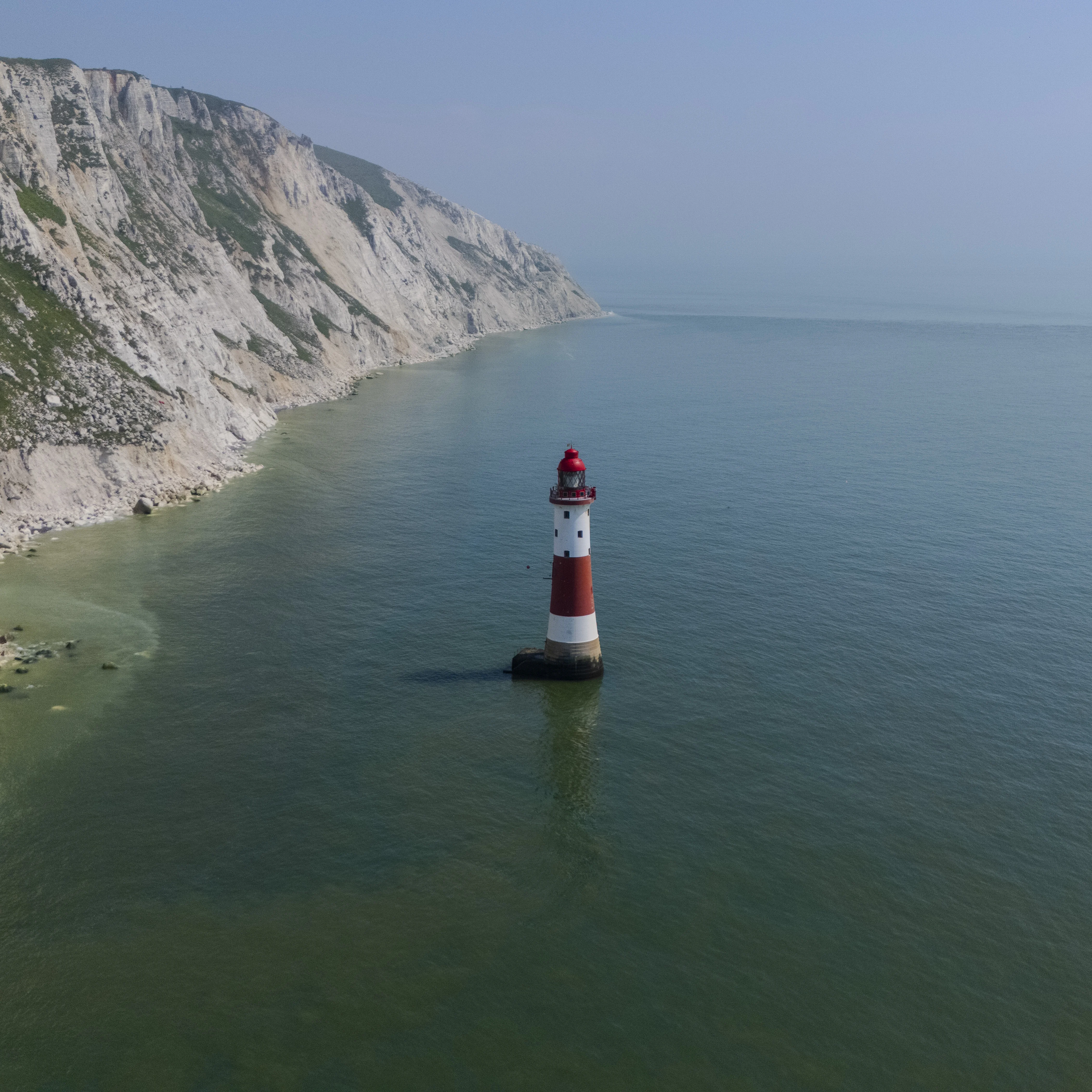 Eastbourne light house standing amongst the waves of the English Channel